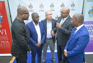 Minister of Tourism, Hon. Edmund Bartlett (second right), makes a point to (from left) Principal of the University of the West Indies (UWI) Mona Campus, Professor Densil A. Williams; Chief Executive Officer of the National Health Fund (NHF), Everton Anderson; Chairman of the Tony Thwaites Wing at the University Hospital of the West Indies (UHWI), Mark Thwaites, and Dean of the Faculty of Medical Sciences, Professor Joseph Plummer. Occasion was the launch of the Faculty of Medical Sciences (FMS) Research Support Fund, at the University of the West Indies, Mona Campus in St. Andrew, today (April 28).