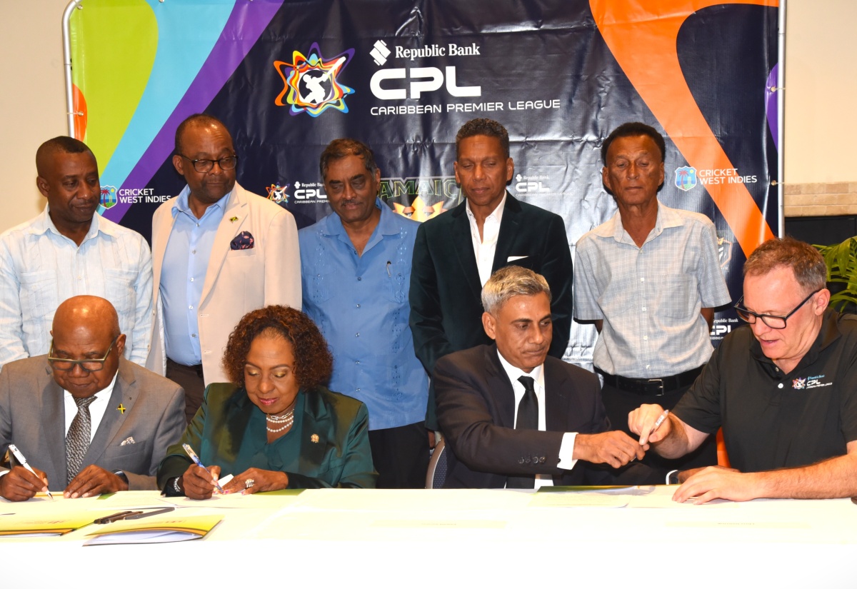 Tourism Minister, Hon. Edmund Bartlett (left, seated); Minister of Culture, Gender, Entertainment and Sport, Hon. Olivia Grange (second left, seated); Owner of the Jamaica Kingsmen Caribbean Premier Leage (CPL) T20 Cricket Franchise, Fawad Sarwar (second right, seated); and CPL Chief Executive Officer (CEO), Pete Russell (right, seated), sign documents during a press conference at the Jamaica Pegasus Hotel in New Kingston on Tuesday (March 31) to announce the new franchise. Looking on (from left, standing) are: Mayor of Kingston, Councillor Andrew Swaby; Tourism Director, Donovan White; Chief Medical Officer for Cricket West Indies (CWI) and the CPL, Dr. Akshai Mansingh; CWI CEO, Chris Dehring; and Jamaica Cricket Association (JCA) President, Dr. Donovan Bennett.
