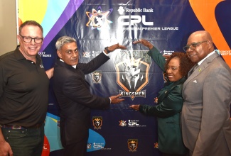 Minister of Culture, Gender, Entertainment and Sport, Hon. Olivia Grange, and Owner of the Caribbean Premier League (CPL) T20 cricket franchise, Jamaica Kingsmen, Fawad Sarwar (second left), unveil the name and logo of the new franchise during a press conference at The Jamaica Pegasus hotel in New Kingston on Tuesday (March 31). Sharing the moment are Tourism Minister, Hon. Edmund Bartlett (right), and CPL Chief Executive Officer, Pete Russell.