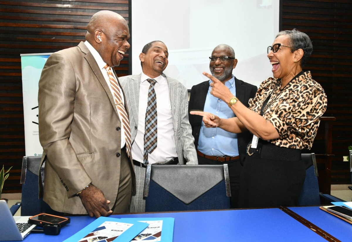 Minister of State in the Ministry of Local Government and Community Development, Hon. Delroy Williams, engages in light conversation with (from left) Director, University of the West Indies (UWI) Centre for Disability Studies, Professor Senator Floyd Morris; Director, Mona Office for Research and Innovation, Professor John Lindo; and Dean of the Faculty of Social Sciences, Dr. Heather Ricketts. Occasion was the opening ceremony for the Seventh Regional Disability Studies Conference at the Faculty of Law Lecture Theatre, University of the West Indies (UWI), Mona on April 28.