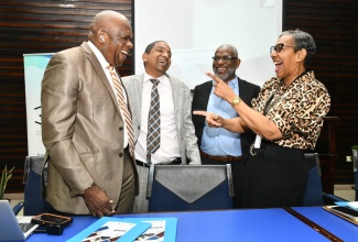 Minister of State in the Ministry of Local Government and Community Development, Hon. Delroy Williams, engages in light conversation with (from left) Director, University of the West Indies (UWI) Centre for Disability Studies, Professor Senator Floyd Morris; Director, Mona Office for Research and Innovation, Professor John Lindo; and Dean of the Faculty of Social Sciences, Dr. Heather Ricketts. Occasion was the opening ceremony for the Seventh Regional Disability Studies Conference at the Faculty of Law Lecture Theatre, University of the West Indies (UWI), Mona on April 28.