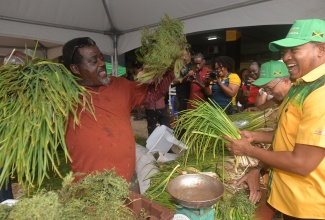 Minister of Agriculture, Fisheries and Mining, Hon. Floyd Green (right), engages with President of the Duff House Agro-Park in St. Elizabeth, Conrad Murray (left), at the Agro-Investment Corporation (AIC) Farmers’ Market, held on Thursday (April 23) at the AMC Complex on Spanish Town Road in Kingston. The Farmers’ Market was held in recognition of Farmers’ Month and provided a market for farmers from agro-parks and other farming groups to sell their produce.