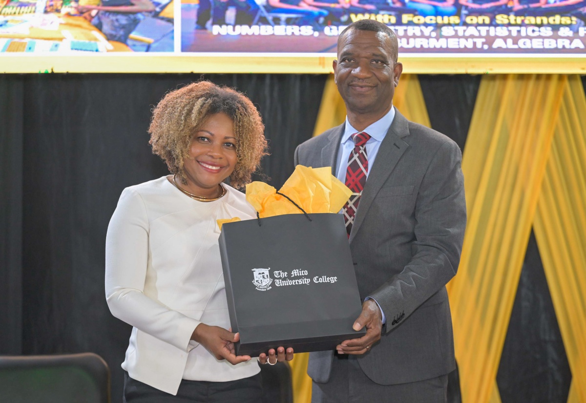 President of The Mico University College, Dr. Asburn Pinnock (right), presents a gift to Minister of Education, Skills, Youth and Information, Senator Dr. the Hon. Dana Morris Dixon, at the University’s recent Mathematics Expo 2026, held at the institution.

