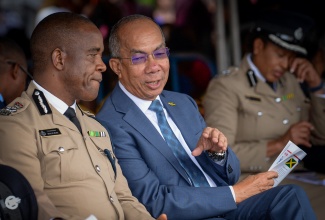 Deputy Prime Minister and Minister of National Security and Peace, Hon. Dr. Horace Chang (right), converses with Police Commissioner, Dr. Kevin Blake, during a Passing Out Parade for Jamaica Constabulary Force (JCF) recruits at the National Police College of Jamaica in St. Catherine.