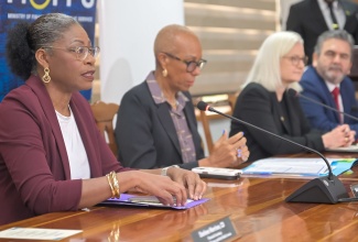 Executive Director of the Transformation Implementation Unit (TIU), Maria Thompson Walters (left), delivers remarks during a ceremony to commemorate the Loan Contract between the Government and the Inter‑American Development Bank (IDB) for the continuation of the Public Sector Transformation Programme. The event was held at the Ministry of Finance and the Public Service on March 27. Also pictured (from second left) are Portfolio Minister, Hon. Fayval Williams; IDB Country Representative in Jamaica, Natacha Marzolf; and Lead Specialist in State Modernisation at the IDB, Mauricio Garcia.