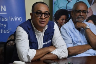 Minister of Health and Wellness, Dr. the Hon. Christopher Tufton (left), addresses a press briefing at the Cornwall Regional Hospital in Montego Bay, St. James, on Thursday (April 9). Joining the Minister is Clinical Coordinator at the Western Regional Health Authority (WRHA), Dr. Delroy Fray. 
