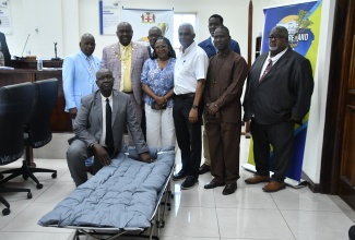 Mayor of Savanna-la-Mar, Councillor Danree Delancy (standing, second left, front row), and Councillors of the Westmoreland Municipal Corporation, share a moment with Director of the Lake Group of Companies, Michael Lake (third right, front row). The occasion was the Corporation’s monthly meeting on April 9, during which Mr. Lake presented 150 cots to bolster emergency response in the parish.
