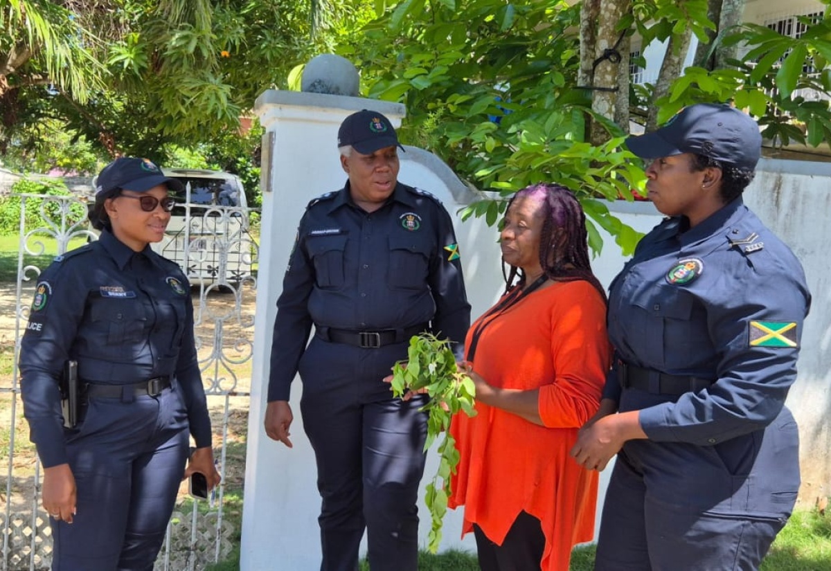 Resident of Hanover, Marcia Whitter-Webster (second right),  interacts with members of the Hanover Police Division (from left), Assistant Divisional Neighbourhood Watch Coordinator, Constable Marshalee Berry;  Territorial Officer, Deputy Superintendent of Police (DSP) Nadine Murray-Brown; and Divisional Neighbourhood Coordinator, Corporal Monique Bartley. 
