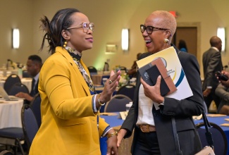 Minister of Finance and the Public Service, Hon. Fayval Williams (right), shares a candid moment with Permanent Secretary in the Ministry of Education, Skills, Youth and Information, Dr. Kasan Troupe, during Wednesday’s (May 13) Government of Jamaica Service Excellence Conference 2026, held at The Jamaica Pegasus hotel in New Kingston.
