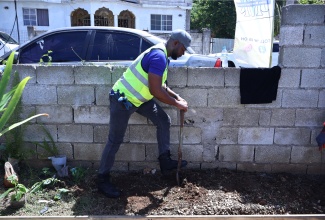 Mayor of Montego Bay, Councillor Richard Vernon, prepares soil for the planting of a garden at the Rose Heights Community Centre on Monday (May 25). Rehabilitation of the community centre is the St. James Parish Project for Labour Day 2026.