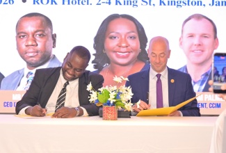 Acting Chief Executive Officer of the Real Estate Board, Cresfroid Brown (left), and Chief Executive Officer of the Certified Commercial Investment Member (CCIM) Institute, Paul Rumler (right), sign a landmark five-year strategic partnership to deliver CCIM designation courses and professional development programmes across Jamaica and the wider Caribbean. The agreement was formalised during the Official Real Estate Training Institute (RETI)-CCIM Partnership Ceremony on Thursday (April 30) at the ROK Hotel Kingston.