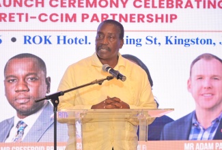 Minister without Portfolio in the Ministry of Economic Growth and Infrastructure Development with responsibility for Land Titling and Settlements, Hon. Robert Montague delivers the keynote address at the Official Signing Ceremony for the Real Estate Training Institute (RETI) and Certified Commercial Investment Member (CCIM) Institute Partnership on April 30 at the ROK Hotel Kingston.