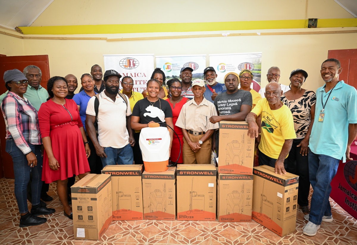 Project Coordinator for the Jamaica Bauxite Institute (JBI) Bauxite Community Development Programme, Amanda Thelwell (front row left), and Senior Project Officer, Wesley Harley (right), are flanked by farmers from Manchester who have benefited from the donation of 100 knapsack sprayers. The presentation took place at Bethabra Moravian Church in Manchester on Thursday (April 30).
