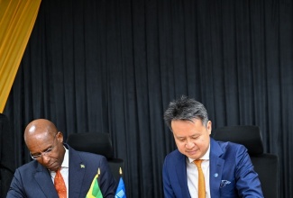 Minister of Industry, Investment and Commerce, Senator the Hon. Aubyn Hill (left), and Director General, World Intellectual Property Organization (WIPO), Daren Tang, sign the Letter of Intent to cooperate on the proposed establishment of an Intellectual Property Training Institution (IPTI) in Jamaica. The signing ceremony was held on Monday (May 18) at the Ministry’s St. Lucia offices in Kingston.