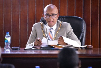 Mayor of Spanish Town, Councillor Norman Scott, addresses the monthly meeting of the Corporation on Thursday (May 14).