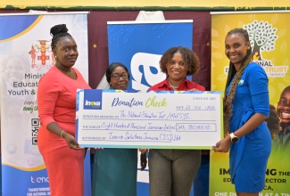  Executive Director of the National Education Trust (NET), Latoya Harris-Ghartey (second right), joins Country Manager for Inova Solutions Jamaica, Kiefa Gay Sandcroft (right), in handing over a cheque for $800,000 to benefit teachers in Manchester and St. Elizabeth. Accepting the donation are Teacher of the St. Elizabeth-based Merrywood Primary School, Shanor Bailey (left), and Principal, Marva McKinnon. The recent presentation ceremony took place at Bethany Primary School in Manchester.
