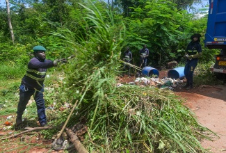 Sanitation workers with the MPM Waste Management Limited carry out a clean-up exercise in the Dark Hole community in Kitson Town, St. Catherine, today (April 30), an initiative spearheaded by the Guanaboa Vale Police.

