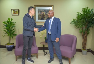 Minister of Industry, Investment and Commerce, Senator the Hon. Aubyn Hill (right), shakes hands with World Intellectual Property Organization (WIPO) Director General, Daren Tang, after brief discussions inside the Courtesy VIP Lounge at Norman Manley International Airport in Kingston, following his arrival on Saturday (May 16) with a delegation for an official visit to Jamaica from May 16–20.