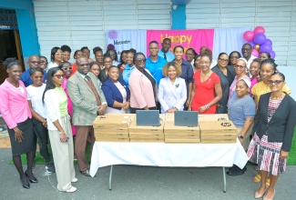 Minister of Education, Skills, Youth and Information, Senator Dr. the Hon. Dana Morris Dixon (fourth right, front row), is joined by Principal of Lawrence Tavern Primary School, Marlene Davis-Fairweather (fourth left, front row); State Minister in the Ministry, Hon. Rhoda Moy Crawford (fifth right, second row); Government Senator, Rose Bennett Cooper (third right, front row); Lawrence Tavern Primary School teachers and other stakeholders during Teachers’ Day Celebration, and the handover of digital devices and a classroom smartboard on the school grounds in St. Andrew on Wednesday (May 6).

