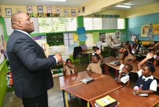 Parliamentary Secretary in the Ministry of Education, Skills, Youth and Information, Senator Marlon Morgan, leads an interactive session with students at Louise Bennett Coverley Primary School, during Read Across Jamaica Day activities at the institution in St. Andrew on Tuesday (May 5).