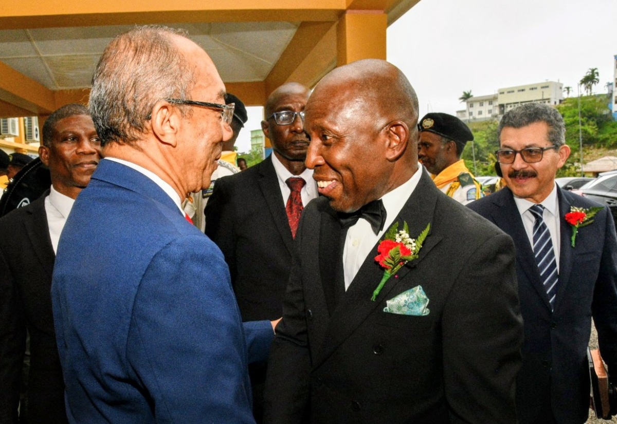 Deputy Prime Minister and Minister of National Security and Peace, Hon. Dr. Horace Chang (left), greets Pastor Glen Samuels upon his arrival at the Jamaica Union Conference of Seventh-day Adventists service of inauguration for the newly elected administration, held at Northern Caribbean University on Saturday (May 9), in Mandeville, Manchester.
