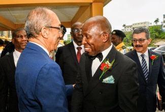Deputy Prime Minister and Minister of National Security and Peace, Hon. Dr. Horace Chang (left), greets Pastor Glen Samuels upon his arrival at the Jamaica Union Conference of Seventh-day Adventists service of inauguration for the newly elected administration, held at Northern Caribbean University on Saturday (May 9), in Mandeville, Manchester.