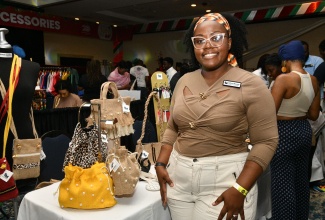 Fashion brand Saffron Maxwell’s Founder and Creative Director, Saffron Maxwell, displays her bag collection during last year