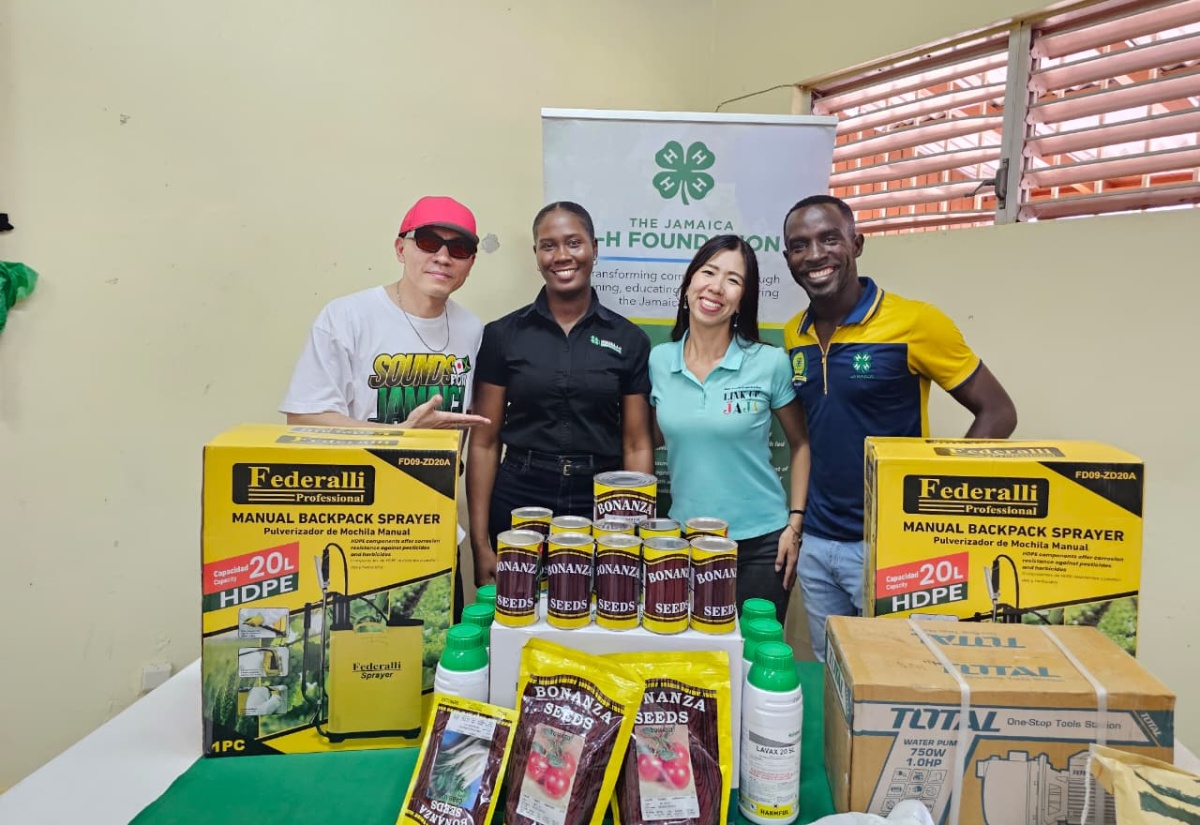 Mighty Crown’s Masta Simon (left), from Japan, hands over donation to Projects Officer for Jamaica 4-H Clubs St. Ann branch, Tanika Allen (second left); Head of LINK UP JAJA, Natsumi Nagamura (third left); and Parish Manager for the Jamaica 4-H Clubs, St. Ann branch, Tedroy Gordon, at the Social Development Commission Parish Office in Brown’s Town, St. Ann, on Thursday, May 14.
