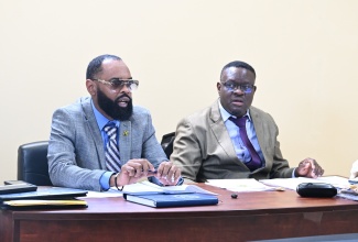 Mayor of Black River, Councillor Richard Solomon (left), addresses the monthly meeting of the St. Elizabeth Municipal Corporation in Black River on Thursday (May 14).  Looking on is Chief Executive Officer, Errol Lebert.
