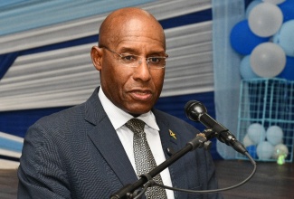 Minister of Industry, Investment and Commerce, Senator the Hon. Aubyn Hill, addresses the audience at the Immaculate Conception High School (ICHS) Young Entrepreneurship Day, held at the school in Kingston on May 29.