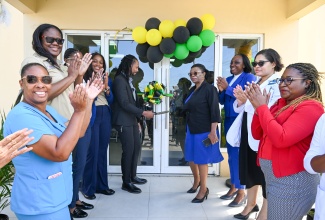 Principal Director for Enabling Environment in Health and Client Services in the Ministry of Health and Wellness, Dr. Kimorley Humphrey (centre), and Parish Manager for Portland Health Services, Joan McPherson (fourth right), lead the ribbon-cutting exercise to mark the launch of the Ministry