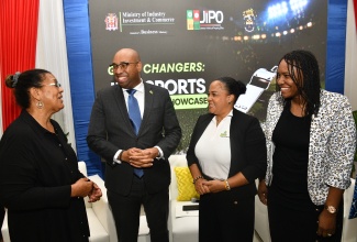 State Minister in the Ministry of Industry, Investment and Commerce, Hon. Delano Seiveright, converses with (from left) Jamaica Intellectual Property Office (JIPO) Executive Director, Lilyclaire Bellamy; Jamaica Anti-Doping Commission (JADCO) Chair, Debby Ann Brown Salmon; and JIPO Deputy Director/Legal Counsel, Shantal English Richards, during JIPO's recent Intellectual Property (IP) and Sports Symposium and Showcase at the University of Technology, Jamaica (UTech) in St. Andrew.
