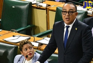 Minister of Health and Wellness, Dr. the Hon. Christopher Tufton, makes his contribution to the 2026/27 Sectoral Debate in the House of Representatives on Tuesday (May 12). Looking on is State Minister, Hon. Crystal Lee.