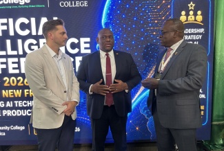 Parliamentary Secretary in the Ministry of Education, Skills, Youth, and Information, Senator Marlon Morgan (centre), is in conversation with Principal, Excelsior Community College, Dr. Philmore McCarty (right), and Co-Founder and Chief Executive Officer of AI Owl, Cas Maxwell, at the Artificial Intelligence Conference and Professional Development Certification Workshop 2026, held recently at Excelsior