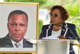 Minister of Culture, Gender, Entertainment and Sport, Hon. Olivia Grange, delivers remarks during a floral tribute at National Heroes Park in Kingston on Monday (May 18), commemorating the 103rd anniversary of the birth of the late former Prime Minister, the Most Hon. Hugh Lawson Shearer.