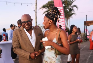Tourism Minister, Hon. Edmund Bartlett, greets travel content creator,Dominique Mills, during the Jamaica Tourist Board