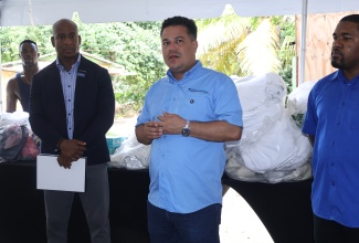 Minister of Water, Environment and Climate Change and Member of Parliament for St. Ann North Eastern, Hon. Matthew Samuda (centre), addresses residents at the Fisherman