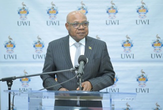 Minister of Tourism, Hon. Edmund Bartlett, delivers the featured address at the launch of the Faculty of Medical Sciences (FMS) Research Support Fund, at The University of the West Indies, Mona Campus, in St. Andrew, on April 28.
