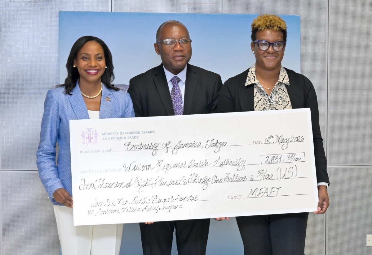 Former Ambassador of Jamaica to Japan, Her Excellency Shorna-Kay Richards (left); Acting Chief Technical Director in the Ministry of Foreign Affairs and Foreign Trade, Ambassador Esmond Reid; and Director of Operations and Maintenance at the Western Regional Health Authority, Michelle-Ann Whyte-Chapman, display cheque during a handover ceremony at the Ministry of Foreign Affairs and Foreign Trade in Kingston on Thursday (May 14). The donation has been made to the Savanna-la-Mar Public General Hospital from the Jamaican Embassy in Japan.
