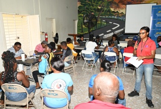 Project Officer for the Community Electrification Project, Jamaica Social Investment Fund (JSIF), Leanne Gordon, engages residents of various communities across Westmoreland during the house-wiring sign-up Initiative at the Savanna-la-Mar Methodist Church in the parish on April 30.