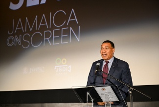 Prime Minister, Dr. the Most Hon. Andrew Holness, addresses the screening of the film 'Love Offside' at the Carib 5 theatre in Cross Roads, Kingston on Friday (May 22).