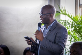 Chairman of the St. Catherine Parish Development Committee (PDC), Bishop Dr. Junior Headlam, addresses the recent monthly meeting of the St. Catherine Municipal Corporation in Spanish Town.