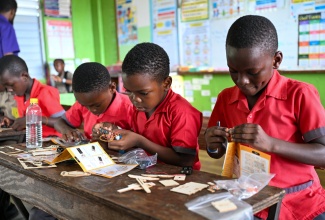 Students of Bath Primary School in St. Thomas participate in hands-on activities during the Eastern Sons Boy Power Summit, held on May 14 at the institution.