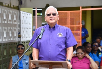 Minister of Justice and Constitutional Affairs, Hon. Delroy Chuck, addresses the reopening ceremony for the Reading Room at Catherine Hall Primary and Infant School in St. James, on May 20.