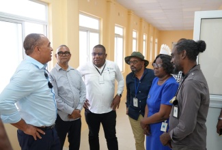 Minister of Health and Wellness, Dr. the Hon. Christopher Tufton, in discussion with (from left) Chairman of the  Southern Regional Health Authority Board, Michael Stern; Regional Director for the  Southern Regional Health Authority, Michael Bent; Parish Manager, St Elizabeth Health Services, Sean Brissett; Director of Nursing Services at Black River Hospital, Maria Stampp, and Senior Medical Officer, Black River Hospital, Dr. Sherriff Imoru, during a tour of the Black River Hospital on April 30.

