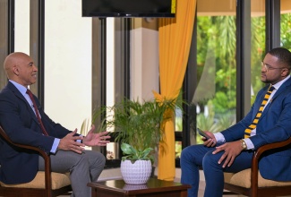 Chief Executive Officer (CEO) of the National Reconstruction and Resilience Authority (NaRRA), Ambassador Major General (Ret’d) Antony Anderson (left), responds to questions during a special interview with the Jamaica Information Service (JIS) CEO, Giovanni Dennis, at the Office of the Prime Minister in Kingston on Tuesday (June 2).
