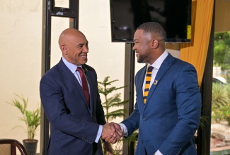 Chief Executive Officer (CEO) of the National Reconstruction and Resilience Authority (NaRRA), Ambassador Major General (Ret’d) Antony Anderson (left), exchanges greetings with CEO of the Jamaica Information Service (JIS), Giovanni Dennis, ahead of an interview at the Office of the Prime Minister in Kingston on Tuesday (June 2).
