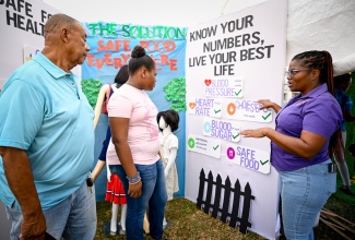Public Health Inspector, Kelli Ann Turner (right), explains the importance of 'knowing your numbers' to (from left) residents of Mandeville, Manchester, Kenneth Simpson, and Jey Anne Williams, during the Southern Regional Health Authority (SRHA) World Food Safety Exposition on Friday (June 5). The event was held at The Greens in Mandeville. The exposition featured exhibitions, panel discussions, competitions, and other activities aimed at promoting food safety awareness, encouraging healthy practices, and fostering safe food handling, preparation, and storage.