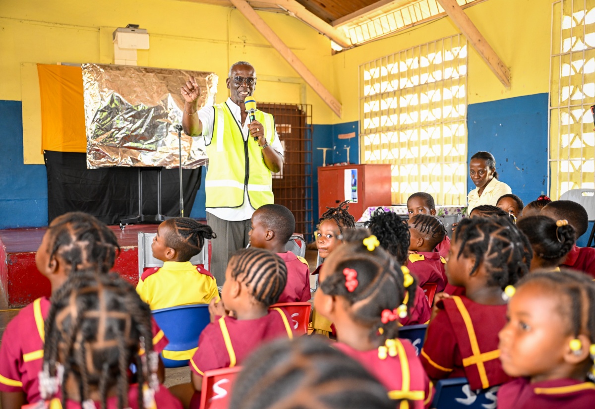 Minister of Local Government and Community Development, Hon. Desmond McKenzie, addresses a public education session at the Salt Savannah Primary and Infant School in Clarendon on June 2. The session was part of the education component of Operation CALM (Cleaning, Advising, Leveraging and Maintaining), which was launched earlier in the day in the Rocky Point community in the parish.