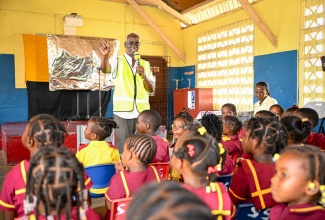 Minister of Local Government and Community Development, Hon. Desmond McKenzie, addresses a public education session at the Salt Savannah Primary and Infant School in Clarendon on June 2. The session was part of the education component of Operation CALM (Cleaning, Advising, Leveraging and Maintaining), which was launched earlier in the day in the Rocky Point community in the parish.